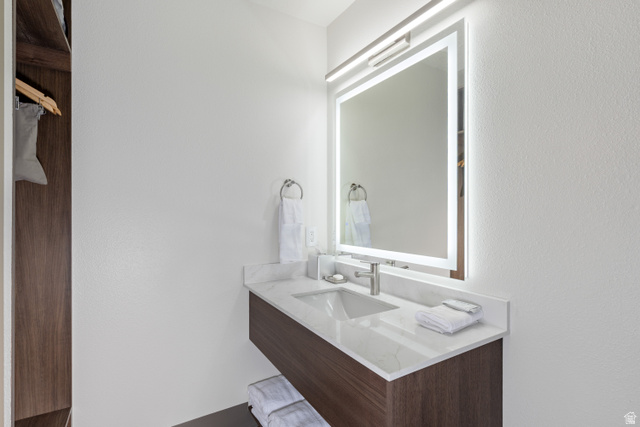 245 Red Cliffs Drive, Unit 104 St. George, UT 84790 - Photo 13 of 33 Bathroom with vanity and a textured wall