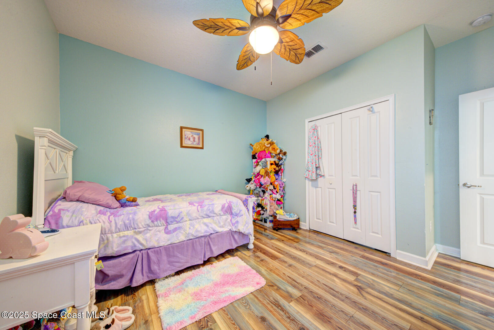 3142 Dark Sky Drive Harmony, FL 34773 - Photo 13 of 54 a bedroom with a bed and a chandelier