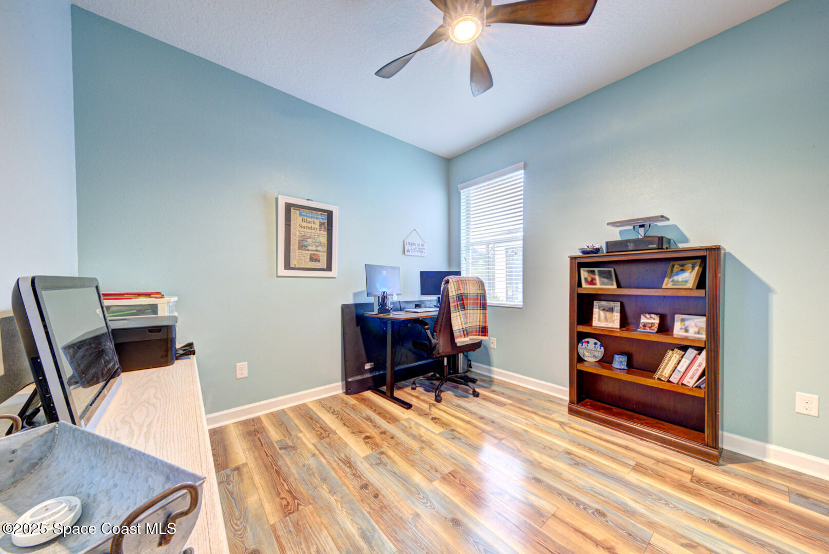 3142 Dark Sky Drive Harmony, FL 34773 - Photo 16 of 54 a workspace with furniture bookshelf and a wooden floor