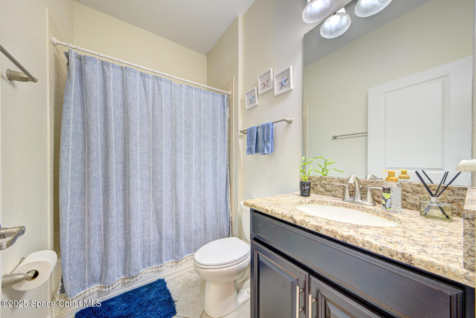 3142 Dark Sky Drive Harmony, FL 34773 - Photo 18 of 54 a bathroom with a granite countertop sink and a mirror
