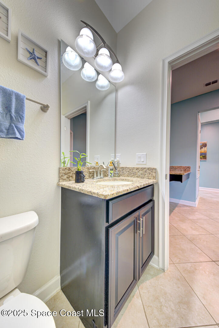 3142 Dark Sky Drive Harmony, FL 34773 - Photo 19 of 54 a bathroom with a sink a toilet and a mirror
