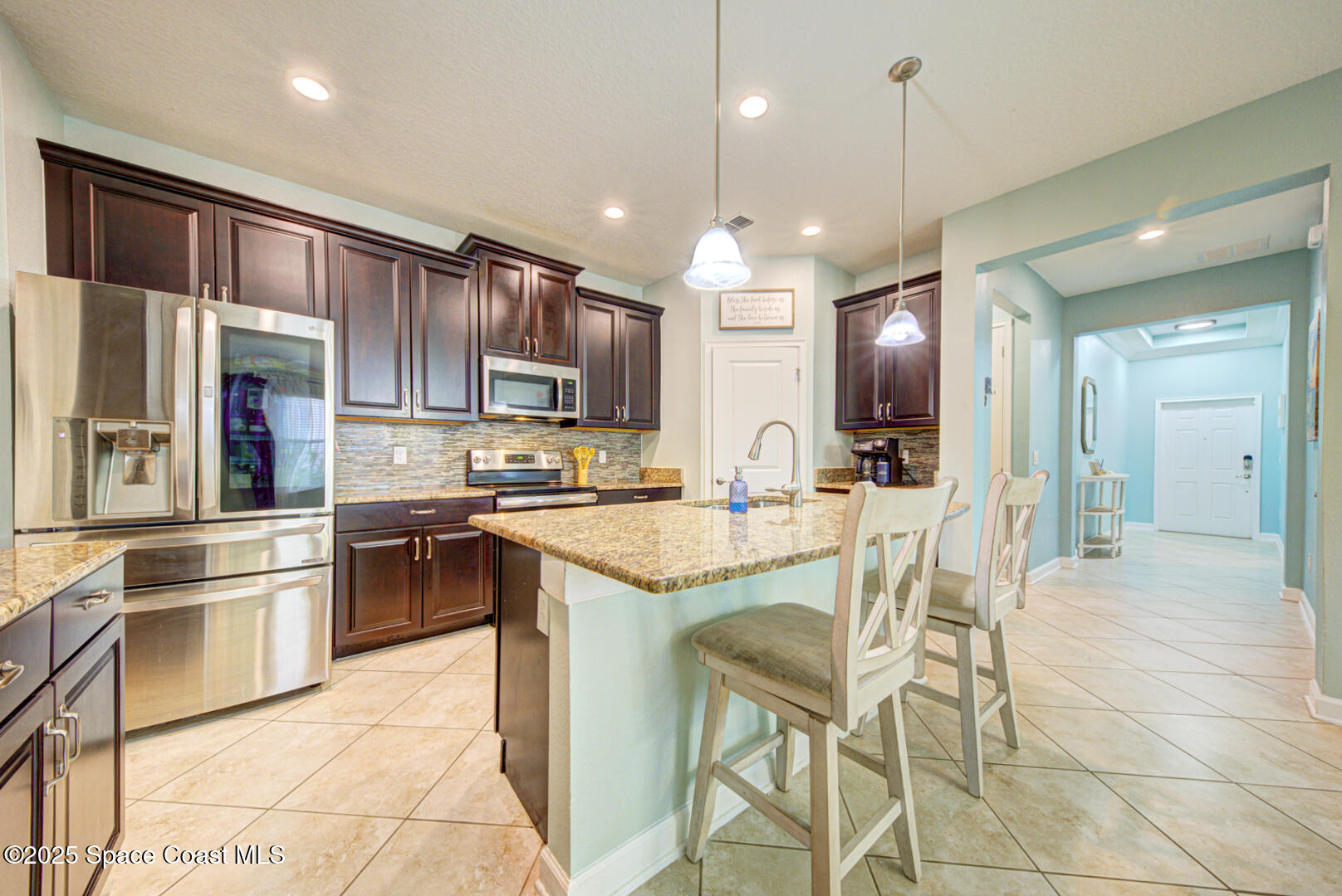 3142 Dark Sky Drive Harmony, FL 34773 - Photo 21 of 54 a kitchen with stainless steel appliances kitchen island granite countertop a sink and cabinets