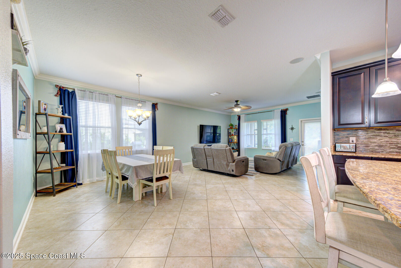 3142 Dark Sky Drive Harmony, FL 34773 - Photo 29 of 54 a living room with furniture a fireplace and a large window