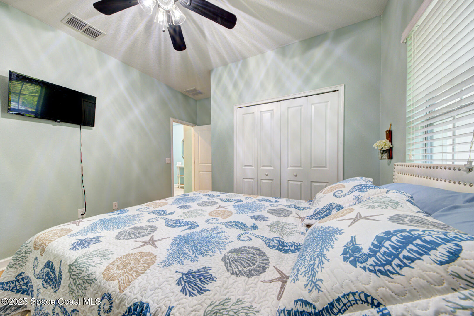 3142 Dark Sky Drive Harmony, FL 34773 - Photo 9 of 54 a bedroom with a large bed and a flat tv screen