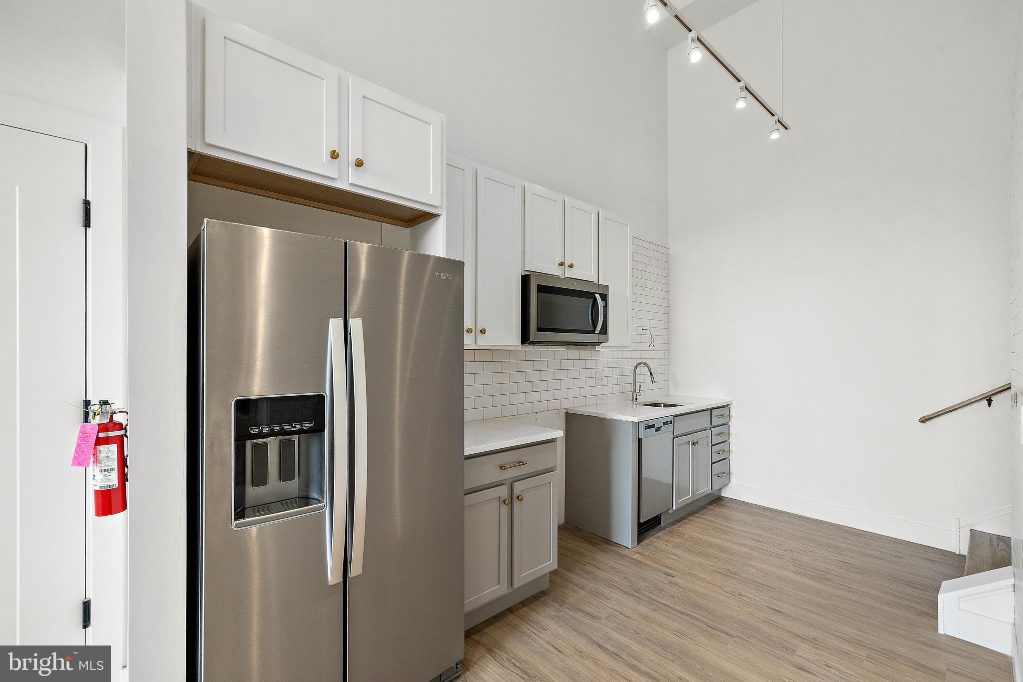 a kitchen with stainless steel appliances a refrigerator stove and microwave