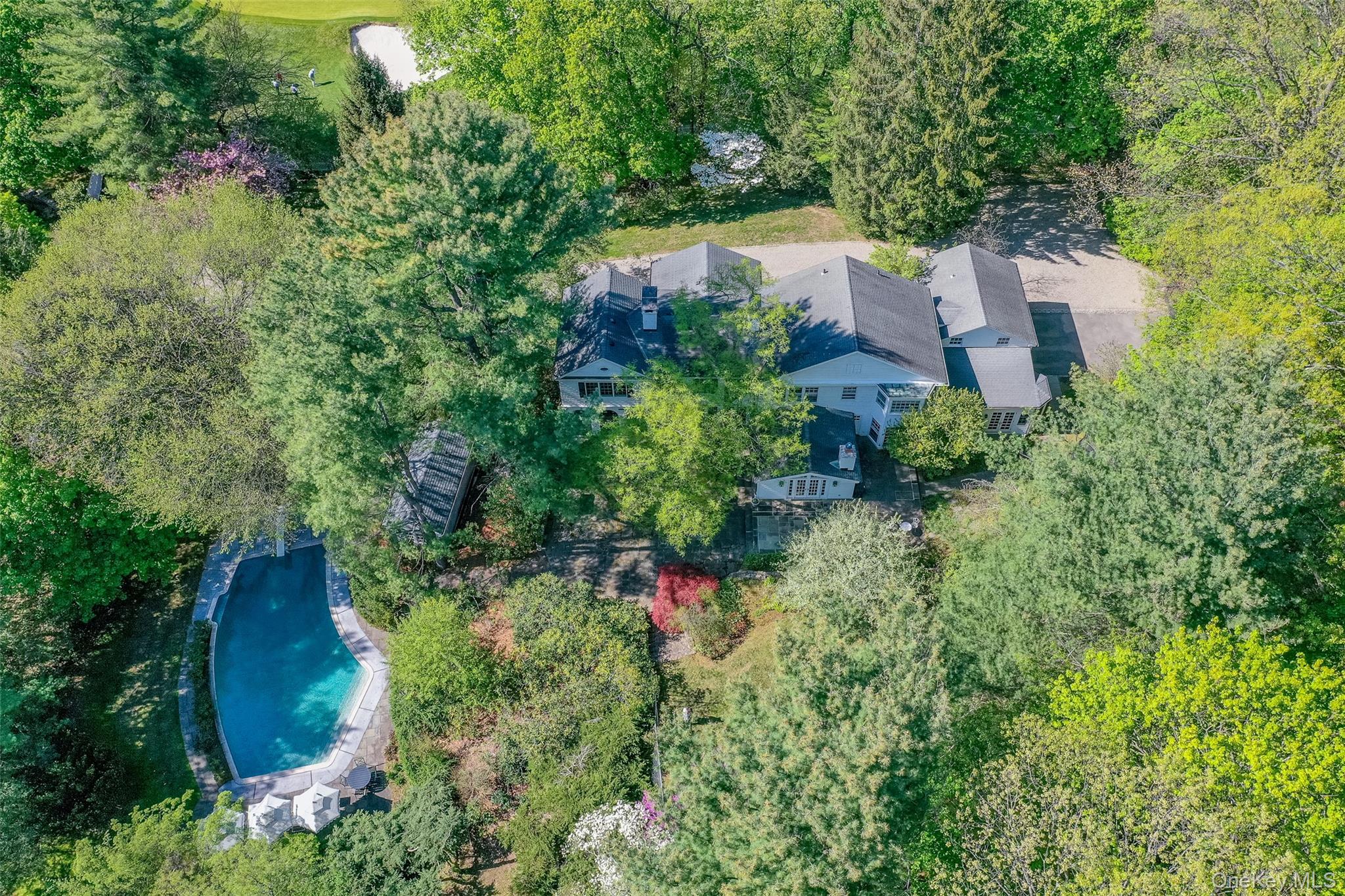 an aerial view of a house with a yard and garden
