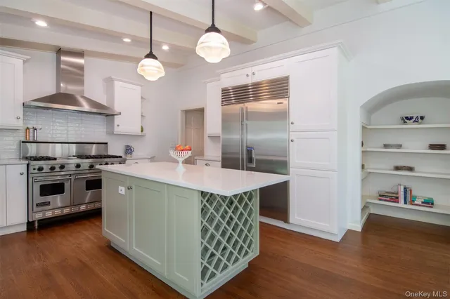 a kitchen with a sink island cabinets and wooden floor