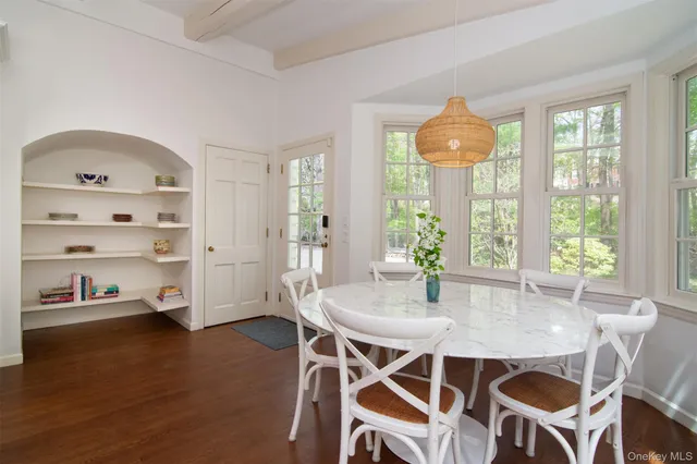 a kitchen with a stove window and wooden floor