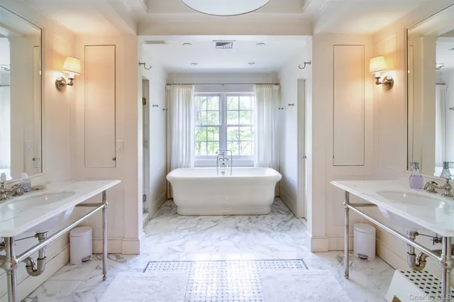 a view of an empty room with wooden floor and windows