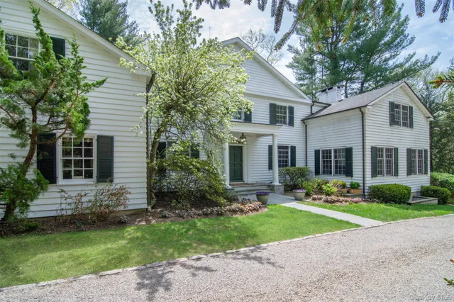 a front view of house with yard and green space