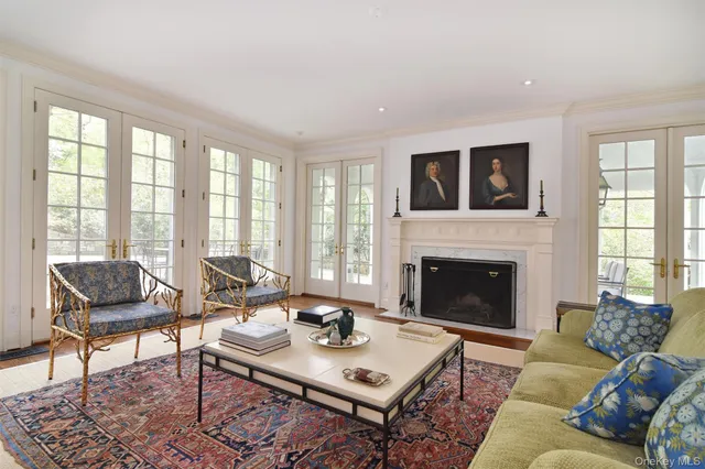 a living room with furniture a fireplace and a table