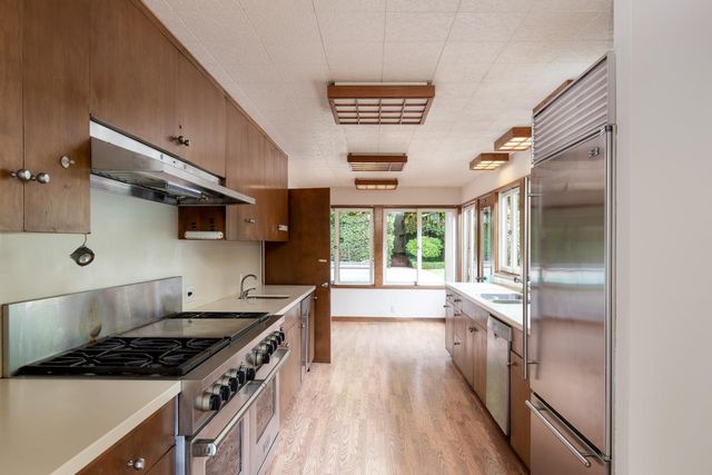 a kitchen with stainless steel appliances granite countertop a stove and a refrigerator