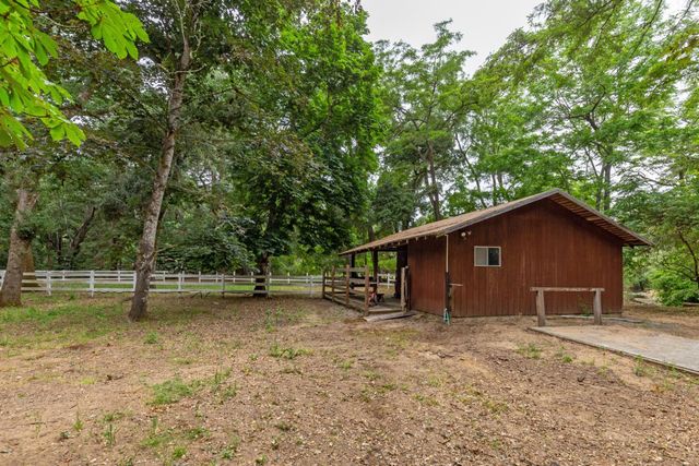 a view of a house with a yard and sitting area