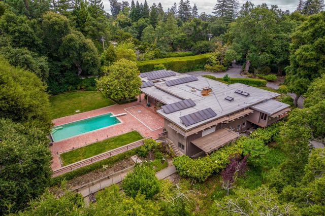 an aerial view of a house with a big yard