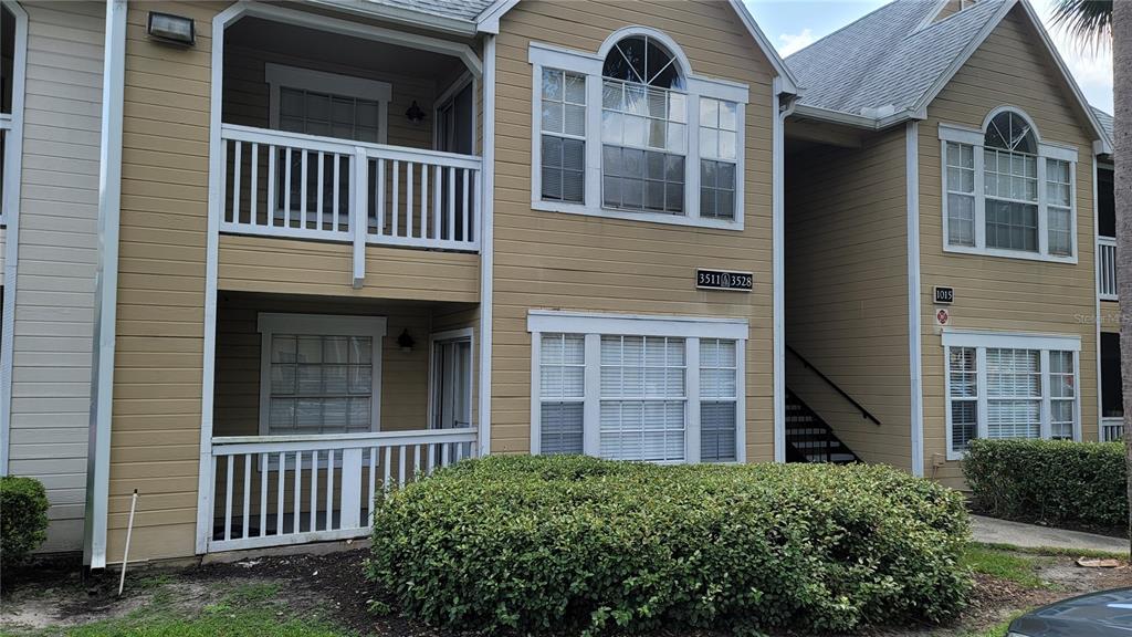 a view of a brick house with large windows