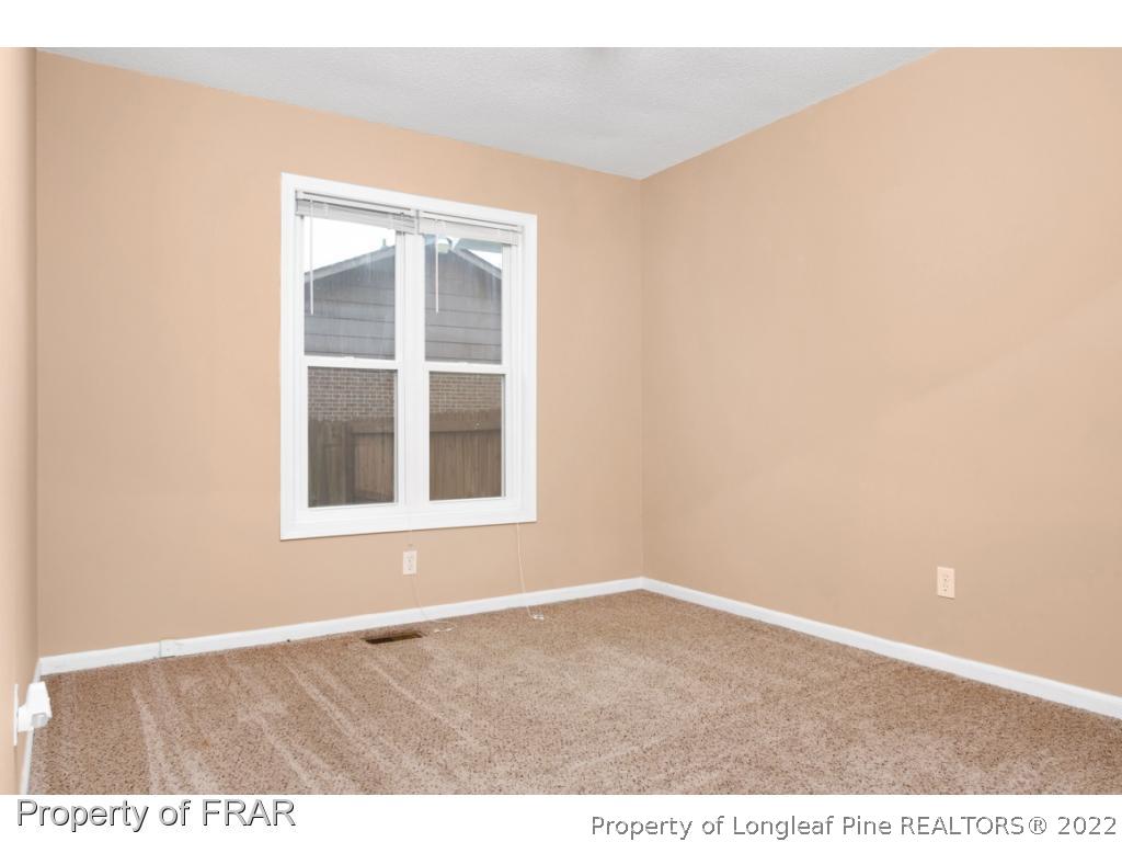 5913 Hunting Ridge Road Hope Mills, NC 28348 - Photo 12 of 20 an empty room with a window