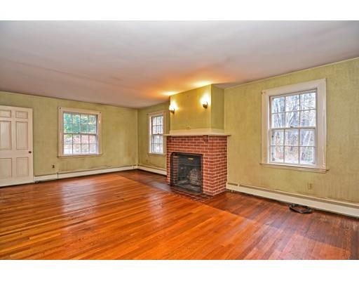 245 Great Road Stow, MA 01775 - Photo 5 of 35 an empty room with wooden floor fireplace and windows