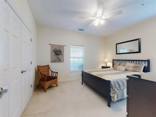 a spacious bedroom with a bed and a chandelier
