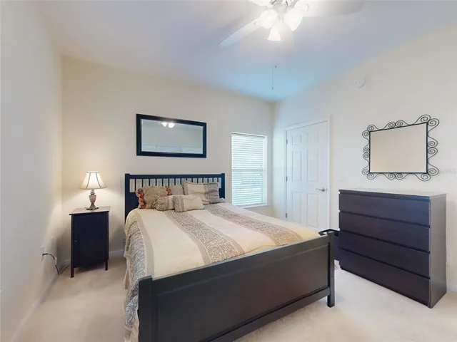 a bedroom with a bed and a painting on the wall