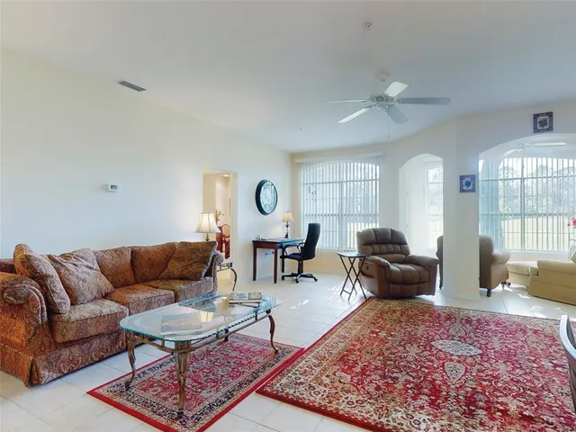 a living room with furniture a rug and a large window
