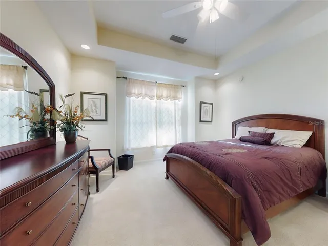 a bedroom with a large bed and a potted plant