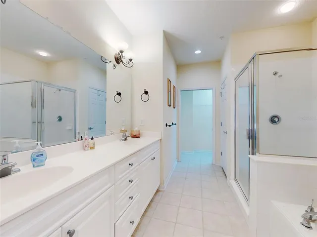 a bathroom with a double vanity sink mirror double and shower