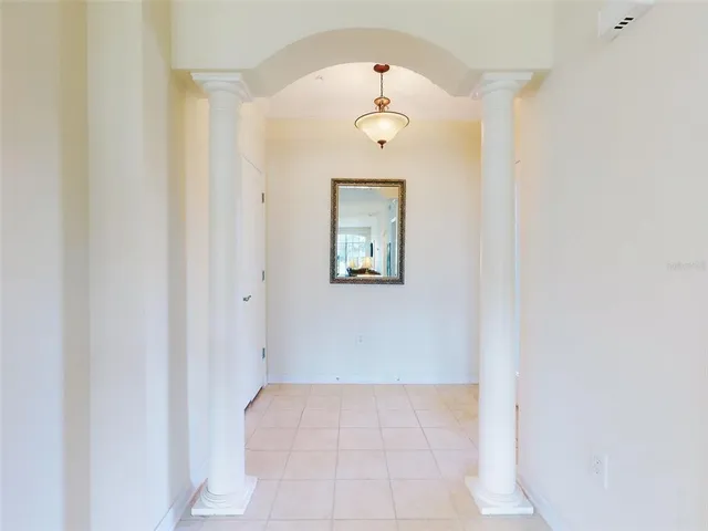 an empty room with a mirror and a window