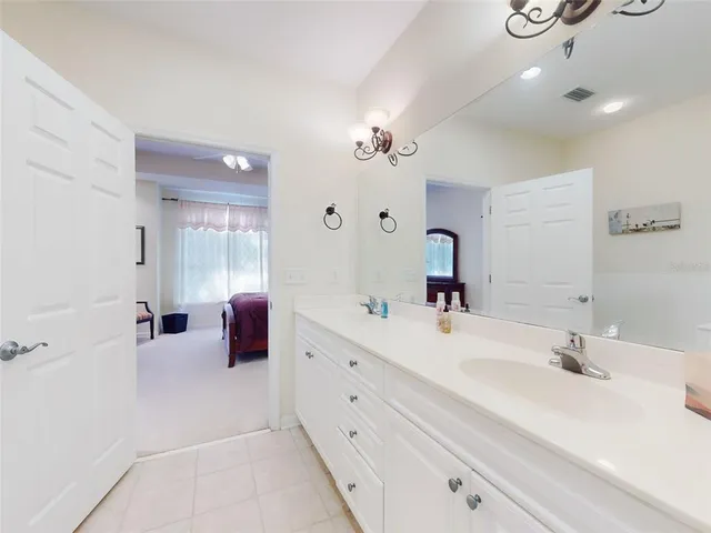 a bathroom with a double vanity sink a mirror and shower