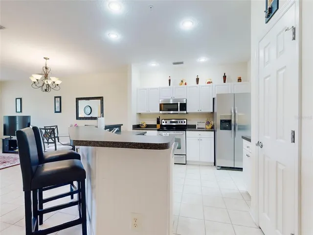 a kitchen with cabinets and chairs
