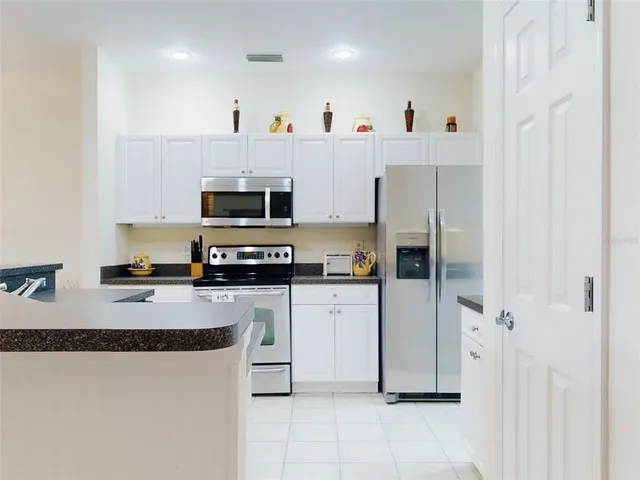 a kitchen with stainless steel appliances a refrigerator sink and microwave