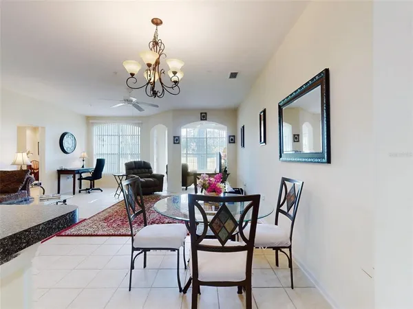 a view of a dining room with furniture and chandelier