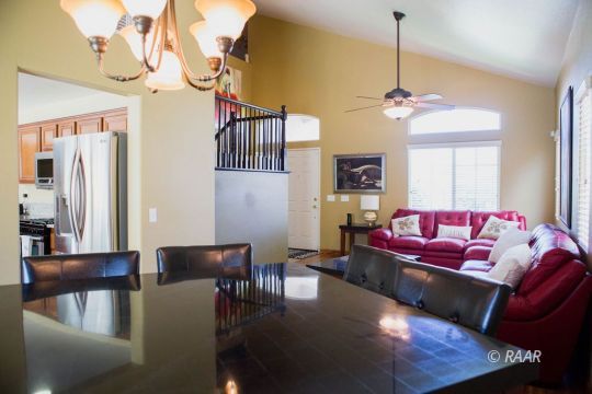1129 Rebecca Avenue Ridgecrest, CA 93555 - Photo 8 of 34 a living room with furniture a dining table and a chandelier