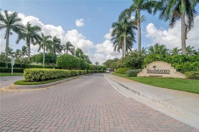 a view of a street with a houses and palm trees