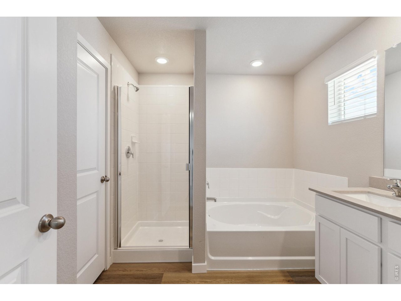 7465 Slate Place Frederick, CO 80530 - Photo 12 of 28 a bathroom with a tub shower and sink
