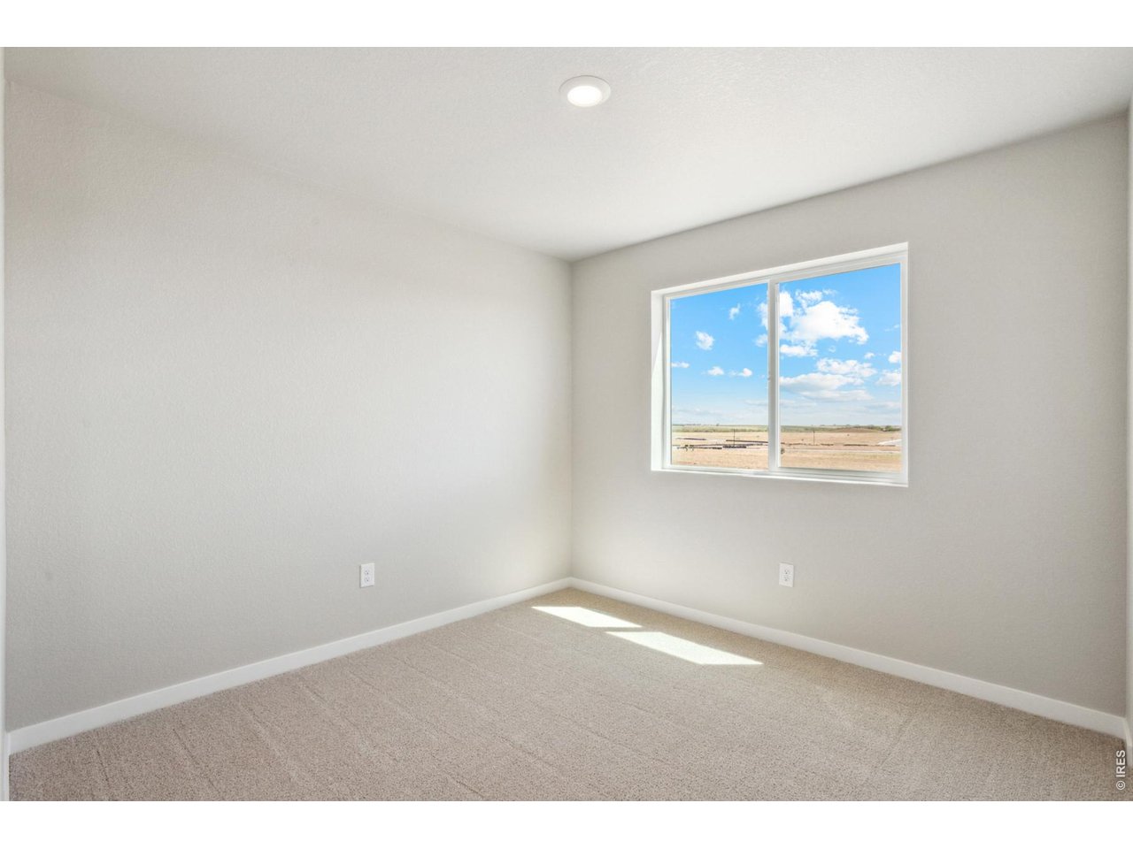 7465 Slate Place Frederick, CO 80530 - Photo 14 of 28 an empty room with windows and closet