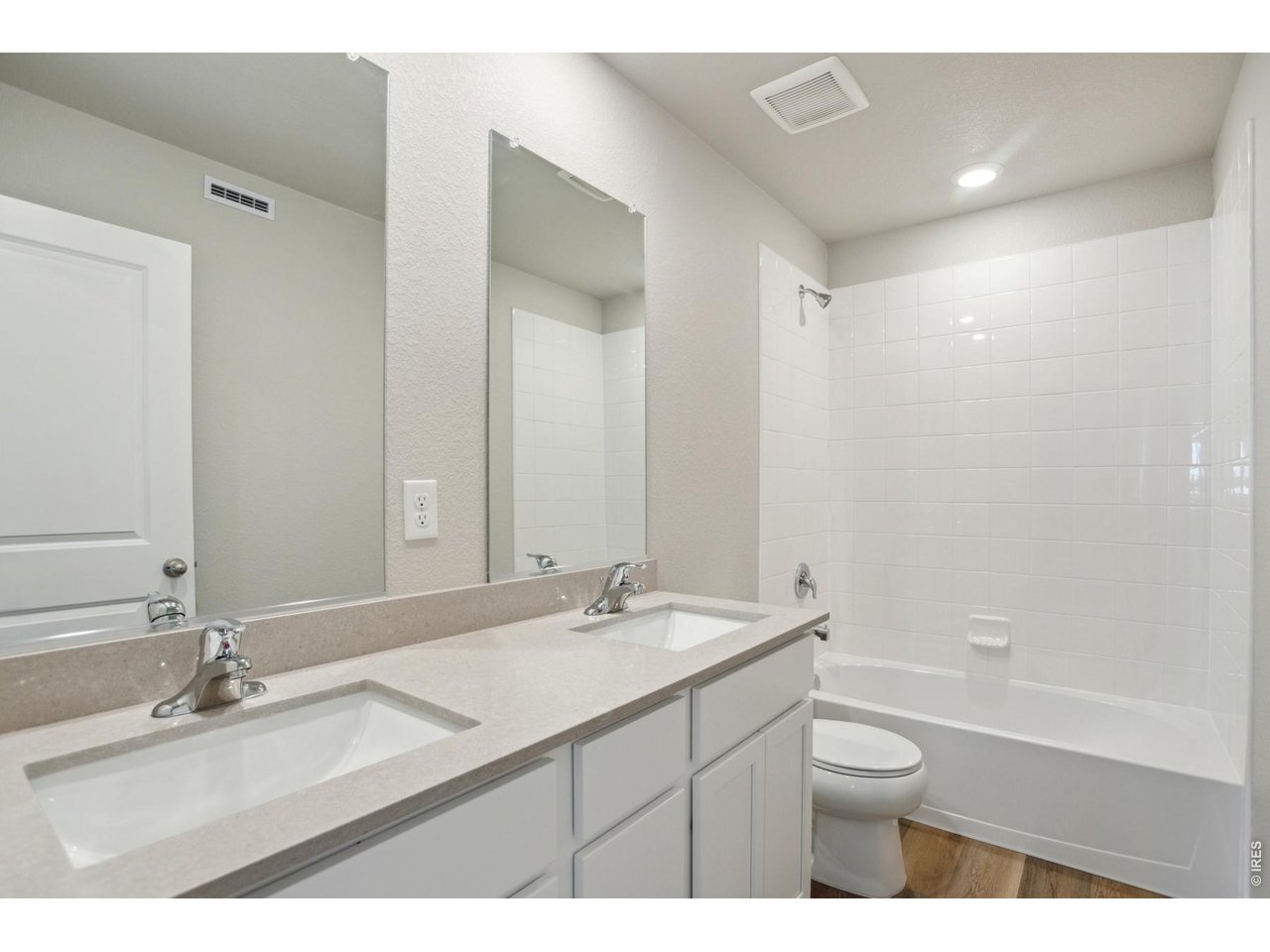 7465 Slate Place Frederick, CO 80530 - Photo 16 of 28 a bathroom with a granite countertop sink mirror toilet and bathtub
