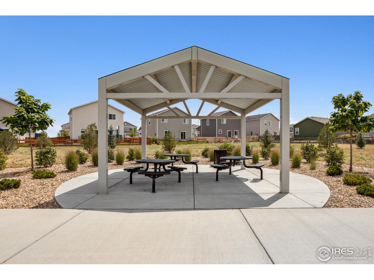 7465 Slate Place Frederick, CO 80530 - Photo 23 of 28 a view of a patio with a table and chairs under an umbrella