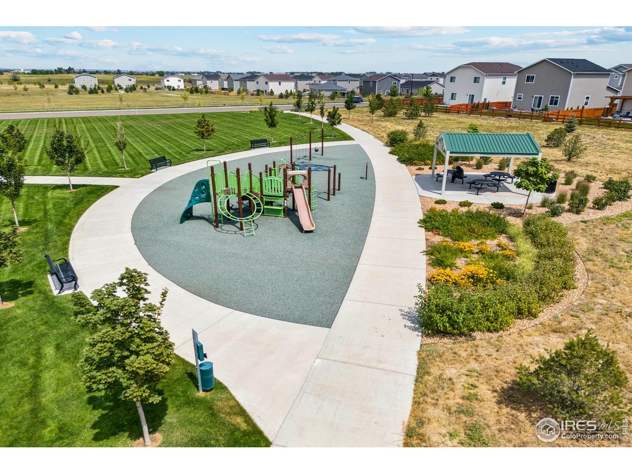 7465 Slate Place Frederick, CO 80530 - Photo 24 of 28 a view of a swimming pool with a garden