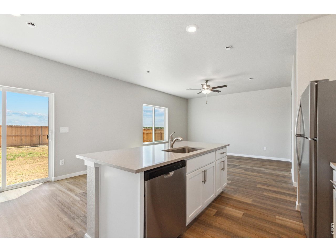 7465 Slate Place Frederick, CO 80530 - Photo 5 of 28 a kitchen with a sink and wooden floor