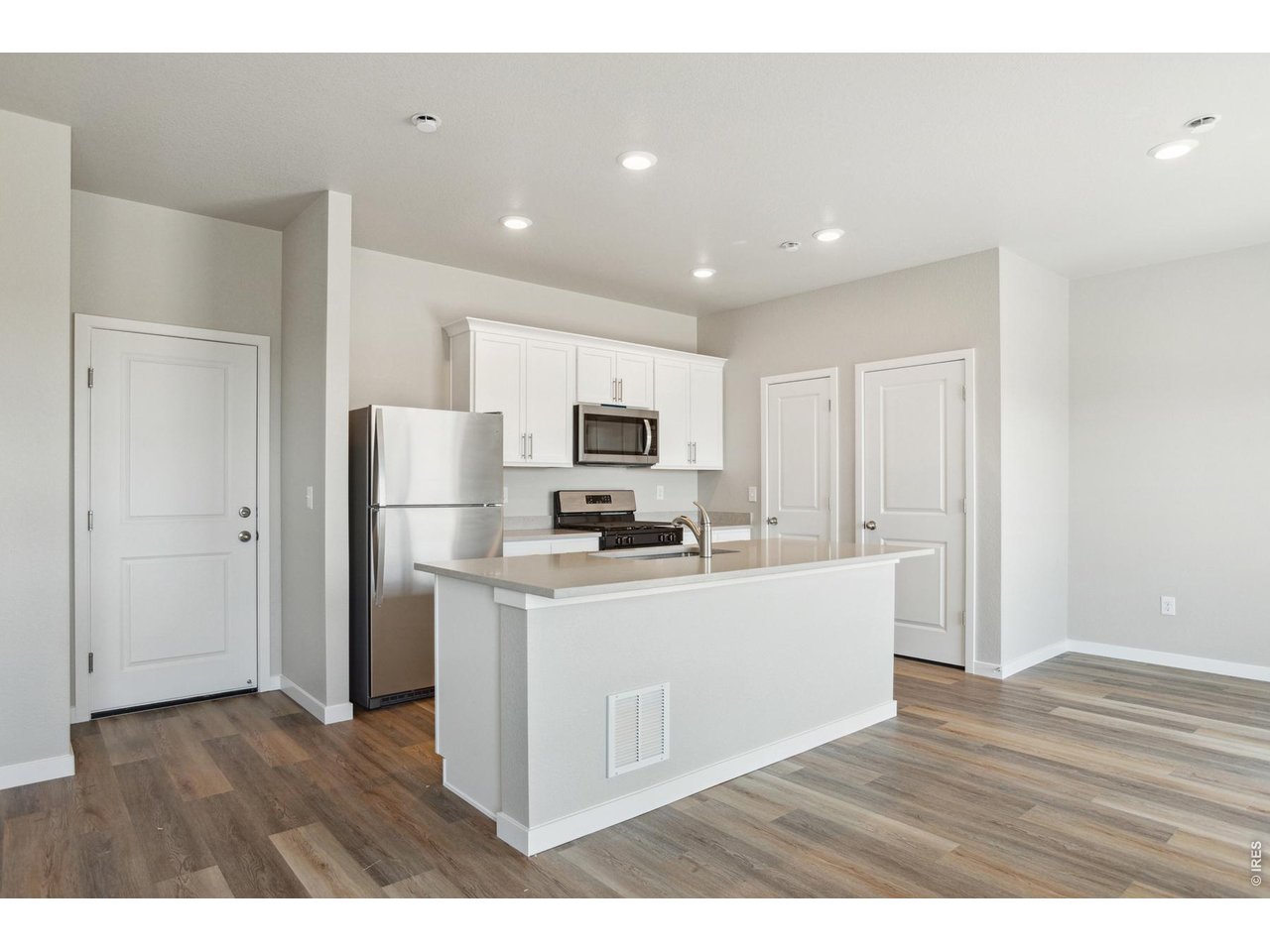 7465 Slate Place Frederick, CO 80530 - Photo 6 of 28 a kitchen with stainless steel appliances a refrigerator and a stove top oven