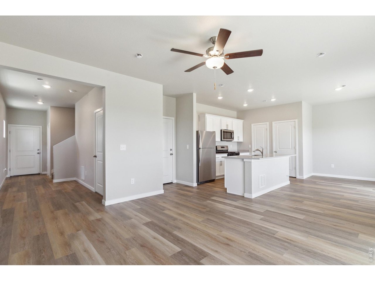 7465 Slate Place Frederick, CO 80530 - Photo 8 of 28 a view of a kitchen with a sink wooden floor and a window