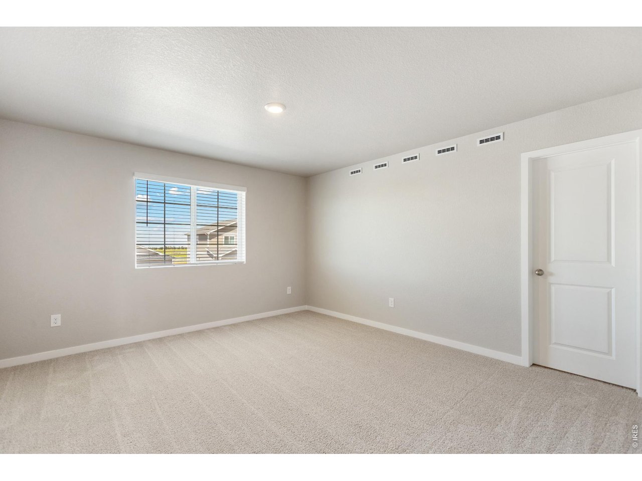 7465 Slate Place Frederick, CO 80530 - Photo 9 of 28 an empty room with windows and closet