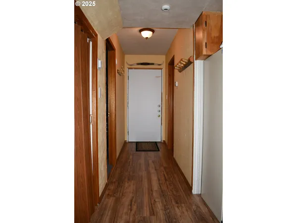 a view of a hallway with wooden floor