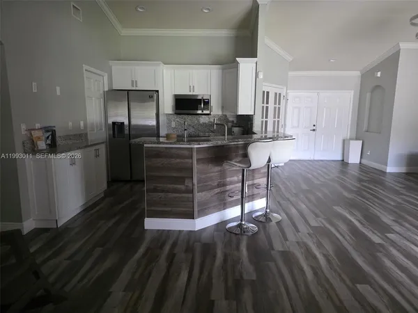 a living room with kitchen furniture and a fireplace