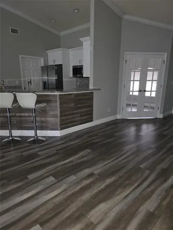 a kitchen with granite countertop a sink and a stove