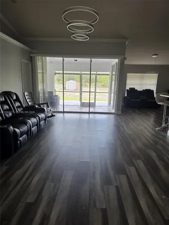 a view of a livingroom with wooden floor and window
