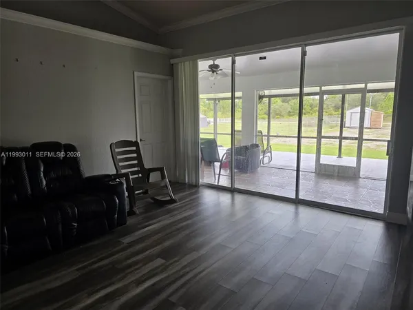 a bedroom with a bed window and chair