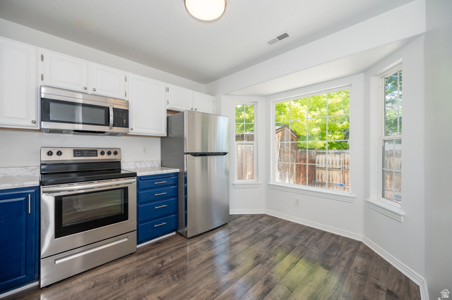 1799 West 1110th Street North Provo, UT 84604 - Photo 7 of 24 Kitchen featuring a full suite of stainless steel appliances, two-tone cabinetry, wood-finish flooring, white countertops, and a bay window