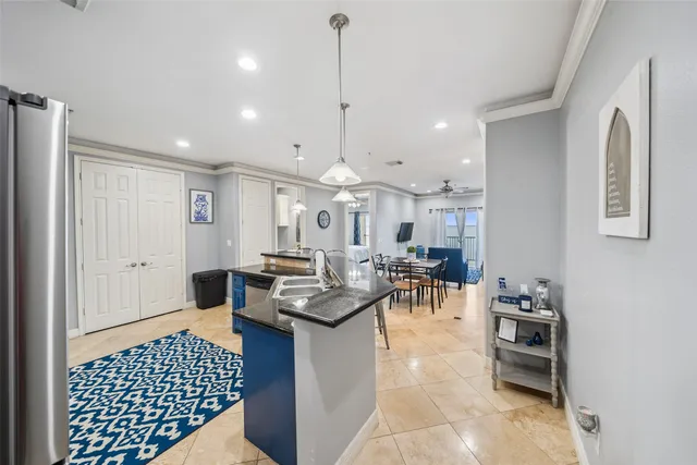a open kitchen with stainless steel appliances granite countertop a stove and a sink