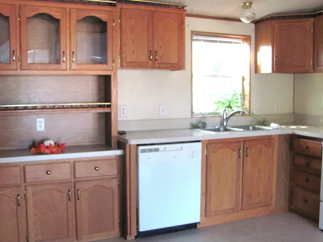 a kitchen with granite countertop white cabinets and sink